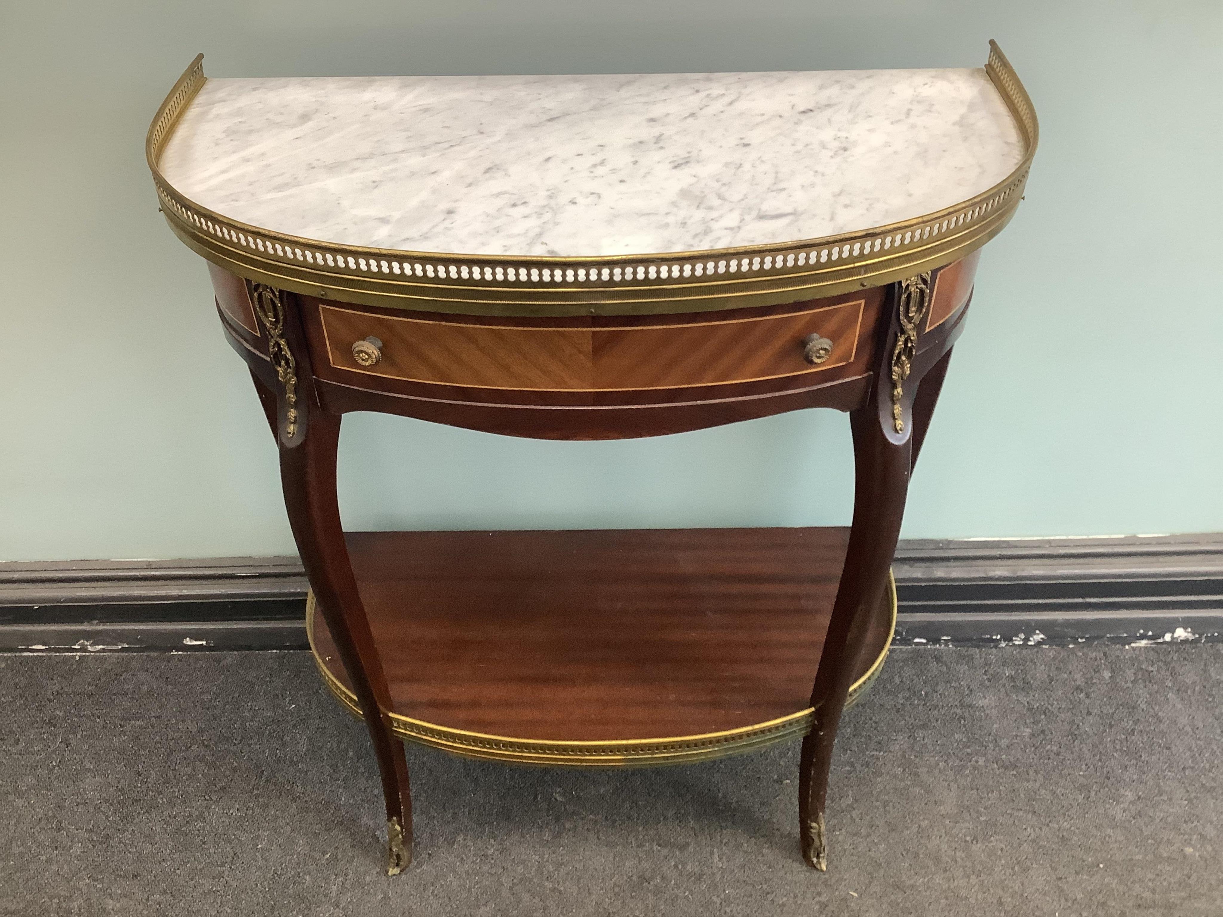 A Louis XVI style gilt metal mounted mahogany two tier marble top side table, width 62cm, depth 31cm, height 73cm. Condition- good